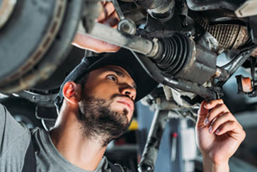 image of AAMCO mechanic inspecting a vehicle