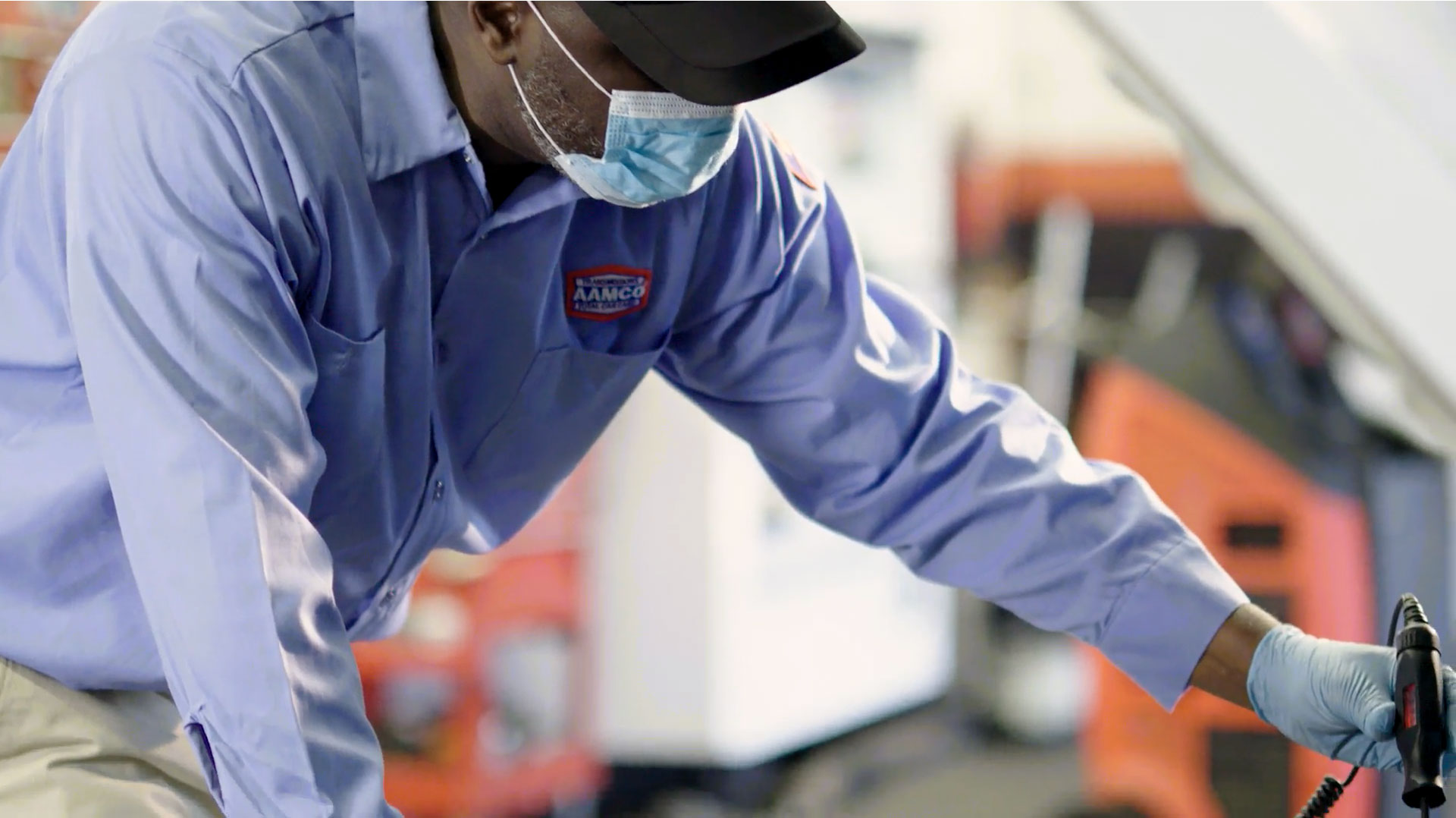 Auto Mechanic Checking Oil